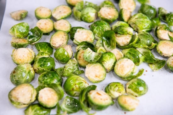 Spreading brussels sprouts on baking sheet pan