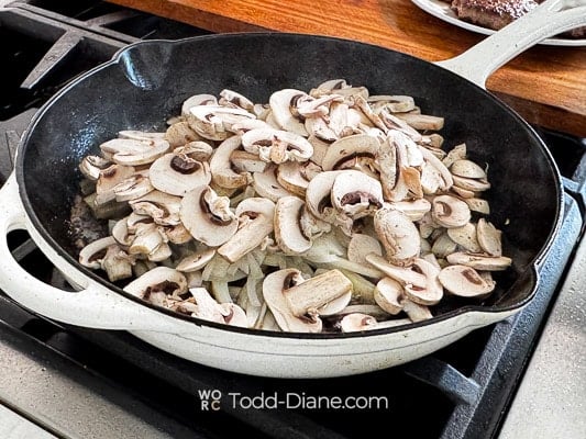 Onions and mushrooms in pan