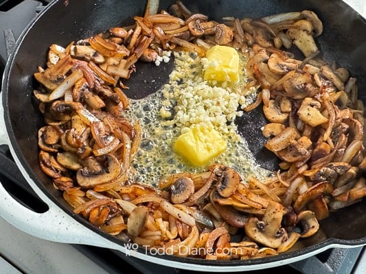 Adding butter and garlic to pan
