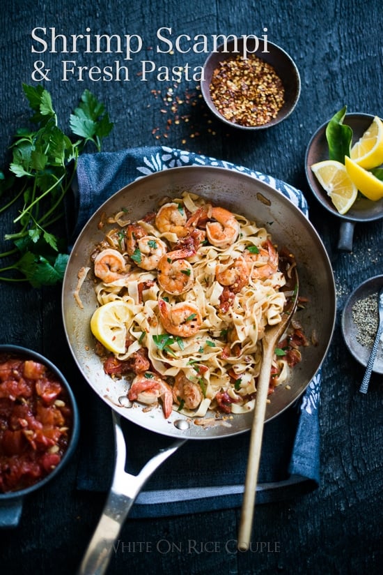 shrimp scampi with fresh pasta in a pan and ingredients 