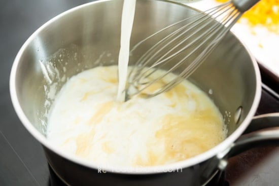 Adding milk to pan