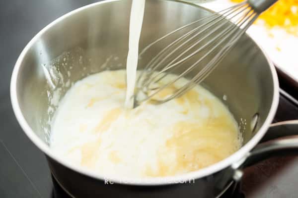 Adding milk to pan