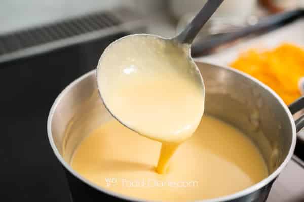 Ladle of cheese sauce