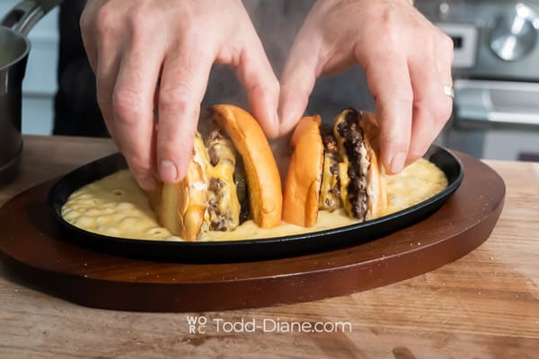 Placing burger cut side down in cheese