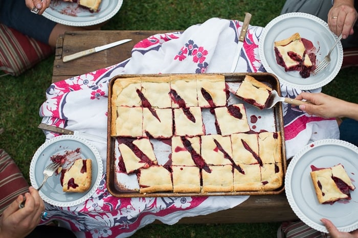Berry Slab Pie Recipe with Chocolate on a baking sheet and plates