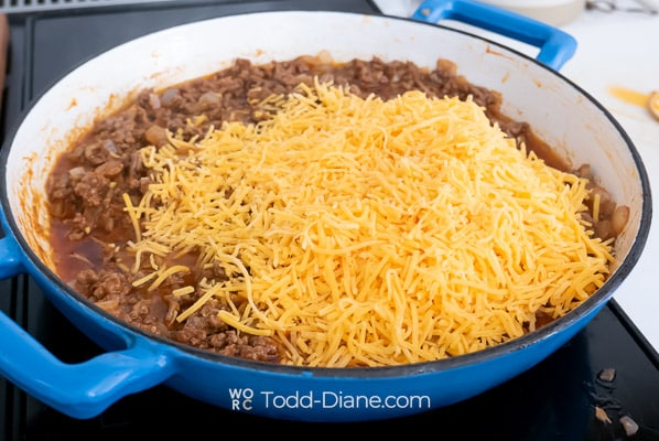 adding shredded cheese