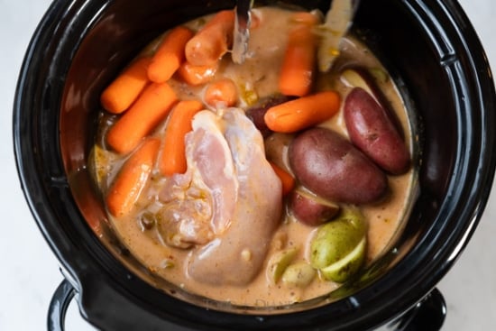 raw chicken, carrots and potatoes in slow cooker curry chicken pot