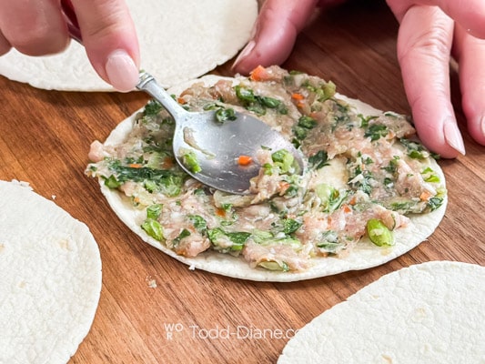 pressing meat against the tortilla