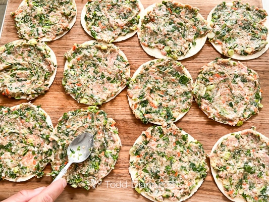 pressing meat over all the tortillas