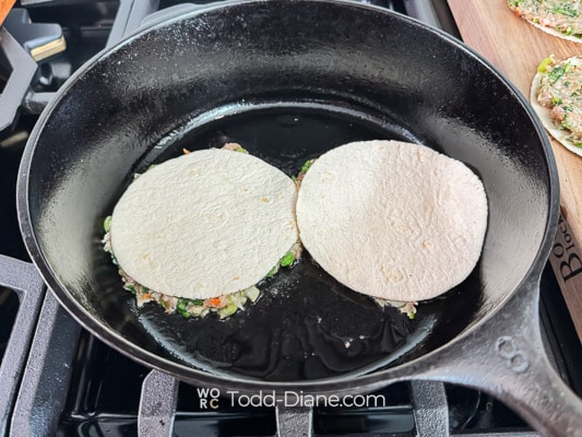 meat side facing down on hot skillet
