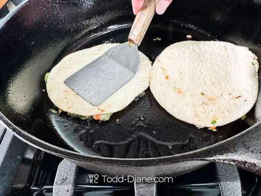 pressing down to smash the taco