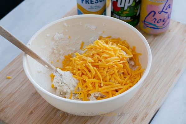 adding cheese to dough