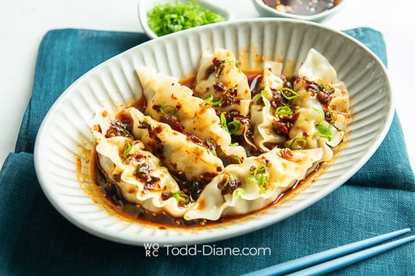 bowl of spicy dumplings in sauce