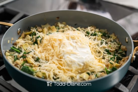 adding cheese and milk