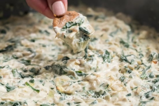 dipping cracker into dip pan