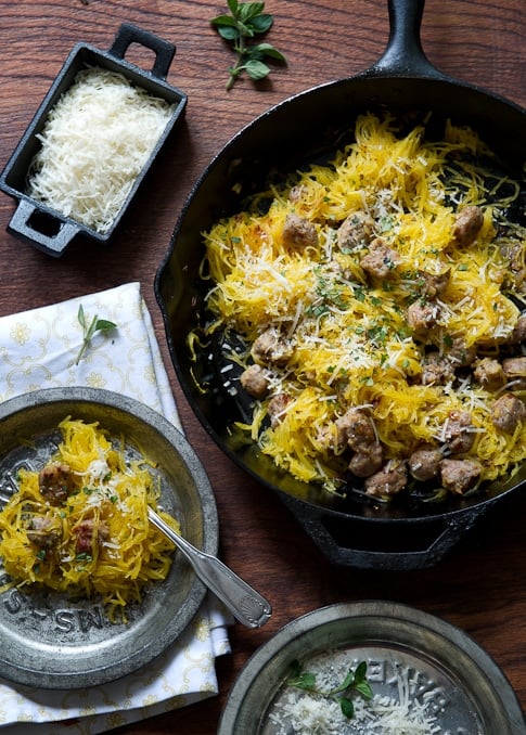 Healthy Spaghetti squash recipe with sausage and parmesan on a skillet