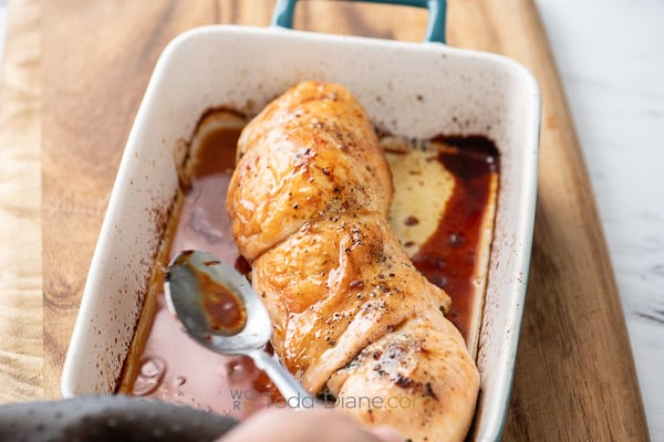 spooning sauce over turkey