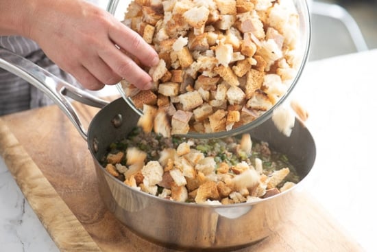 adding croutons to stuffing mix