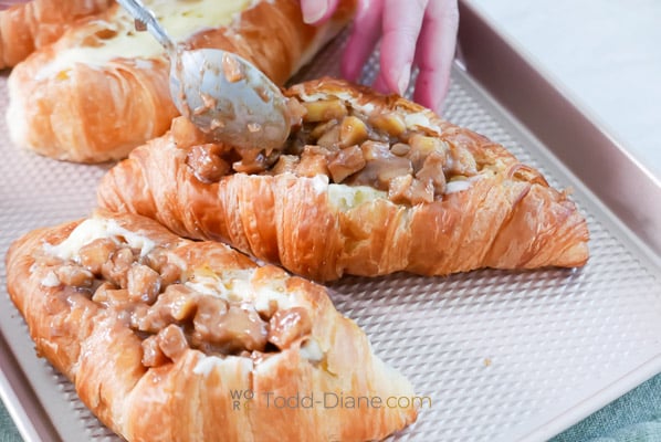 adding apple pie filling in croissant