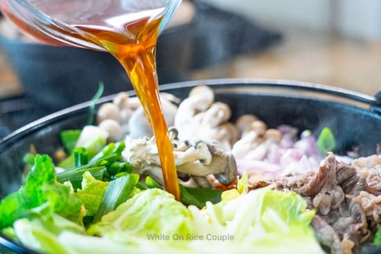 Pouring the sukiyaki broth into the pan