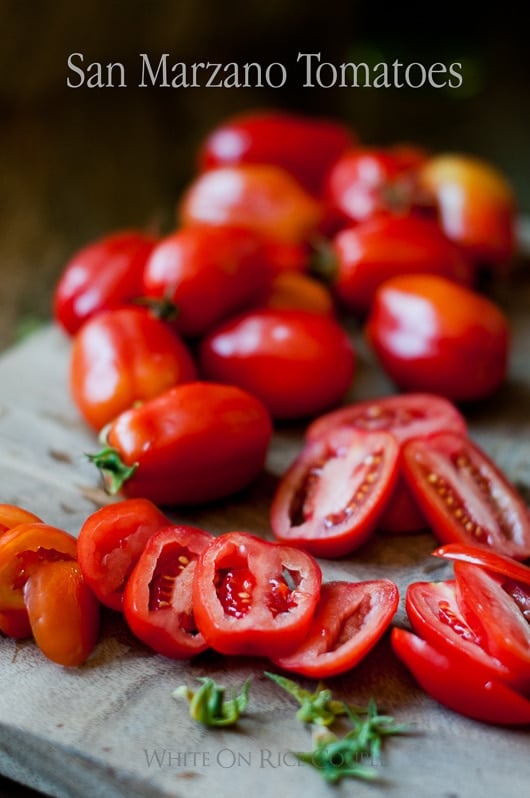 san marzano tomatoes sliced on a cutting board