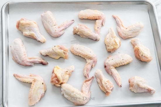 Wings laid out on baking sheet pan