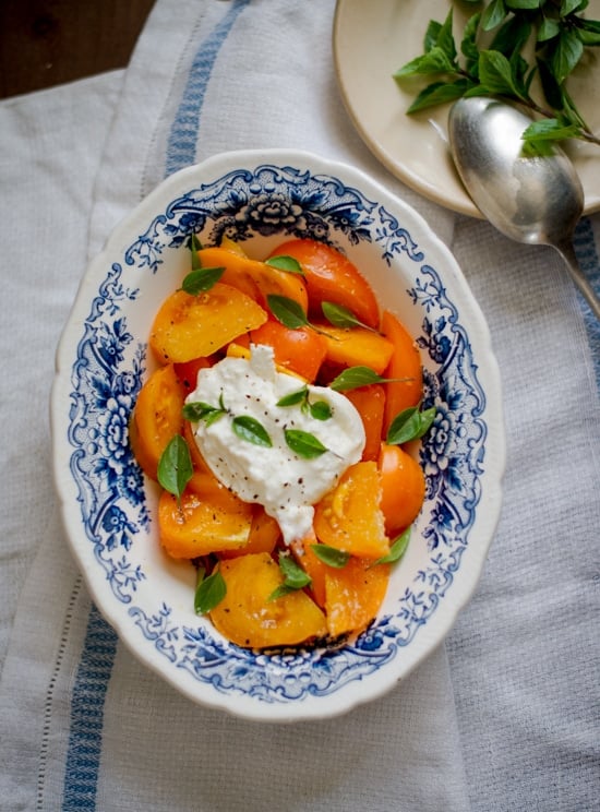 Tomato Salad Recipe with Burrata Cheese on a serving dish