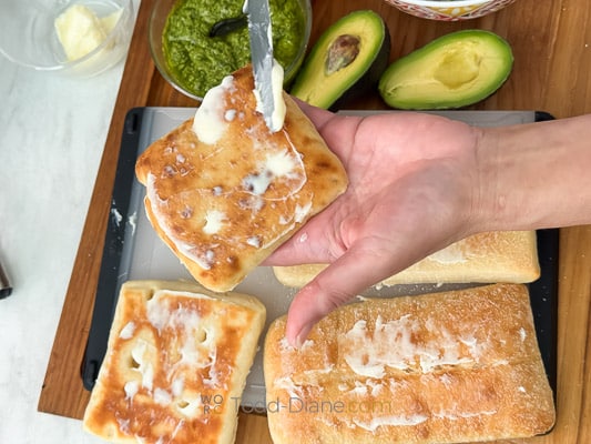adding butter to bread