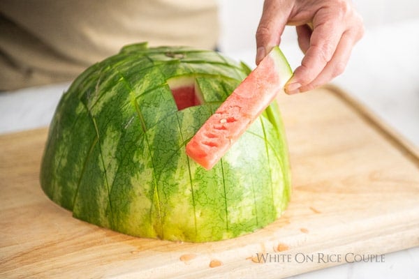 holding watermelon sticks 