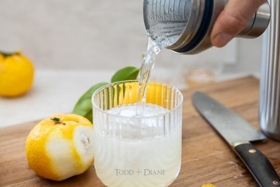 Adding club soda to cocktail