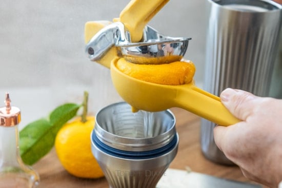 Squeezing fresh yuzu into a shaker