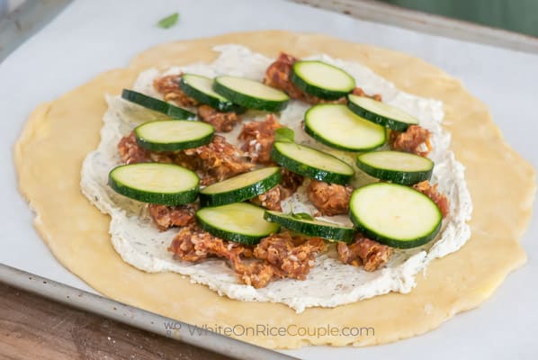 layering sausage and zucchini